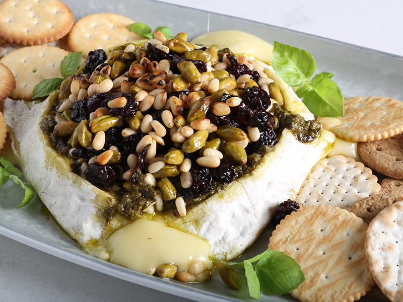 Barilla Rustic Basil Pesto Topped Baked Brie with honey glazed dried fruit and nuts
